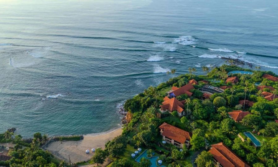 A breathtaking view of Cape Weligama Resort in Sri Lanka with stunning ocean vistas, lush greenery, and luxurious accommodations.