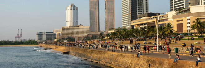 Side view of Galle Face Green with a backdrop of buildings