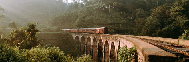 A view of a train traveling on the Nine Arch Bridge