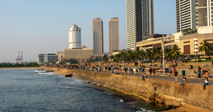 Side view of Galle Face Green with a backdrop of buildings